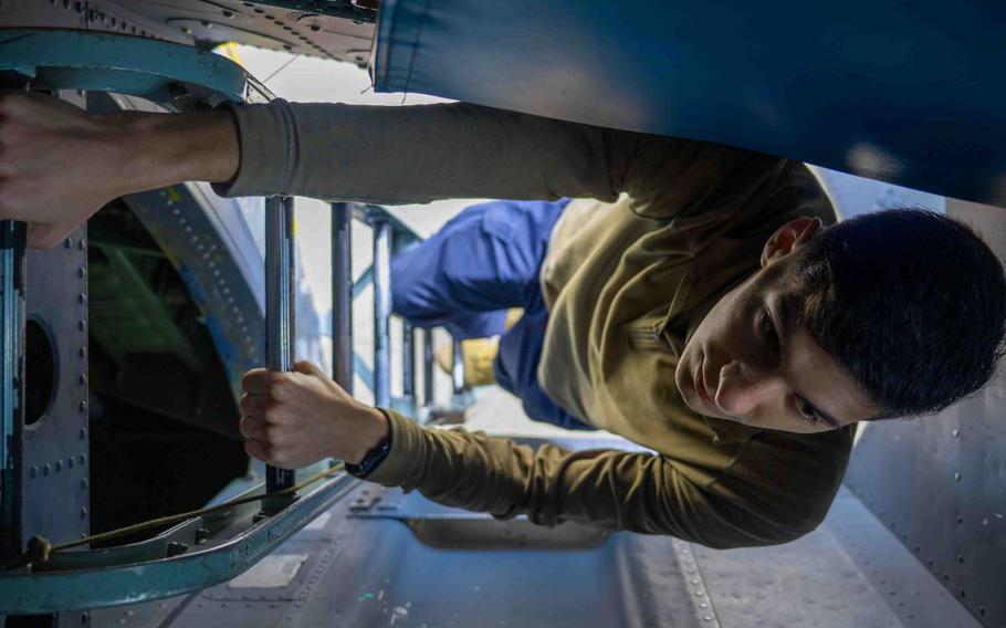 U.S. Air Force Senior Airman Tristan Merritt, 82nd Reconnaissance Squadron electronic warfare journeyman, enters an RC-135 Rivet Joint at Kadena Air Base, Japan, Feb. 18, 2025. Merritt conducted maintenance inside the RC-135 to ensure systems continue to have high quality signals to ensure mission success and provide intelligence capabilities in the Indo-Pacific.
